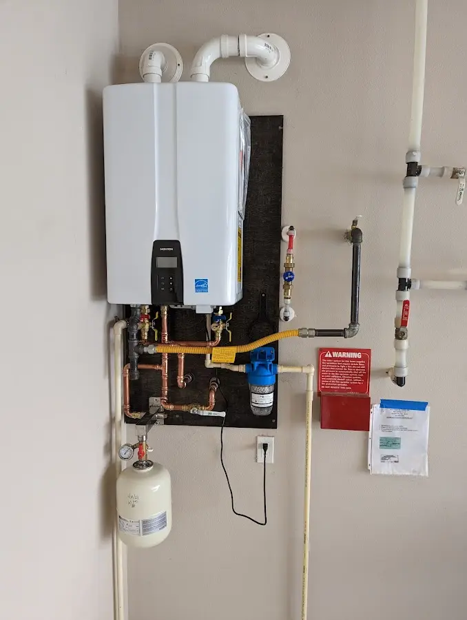 Professional plumber installing copper piping in a Saugus home